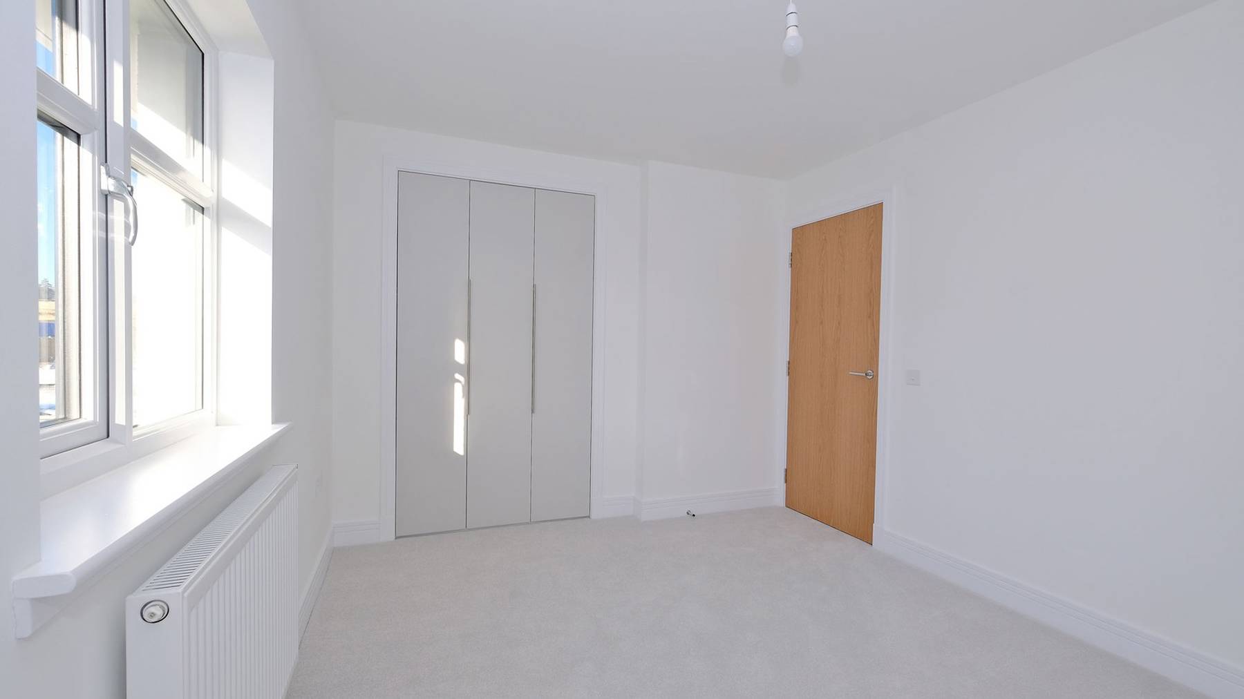 Bright bedroom with built in wardrobes 