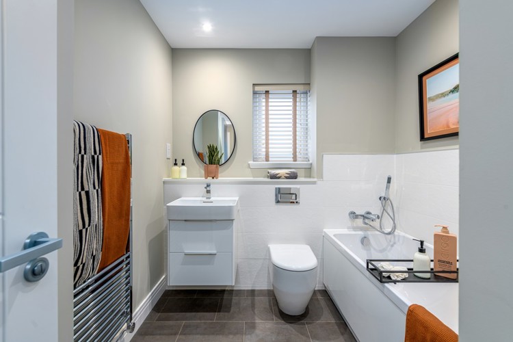 4 bedroom showhome | stylish family bathroom with sleek fittings and half-height tiling