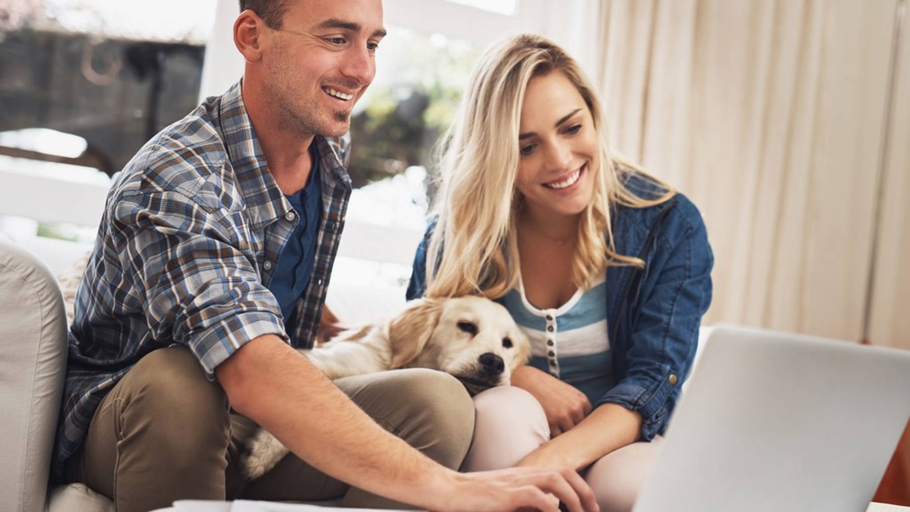 couple and dog on laptop