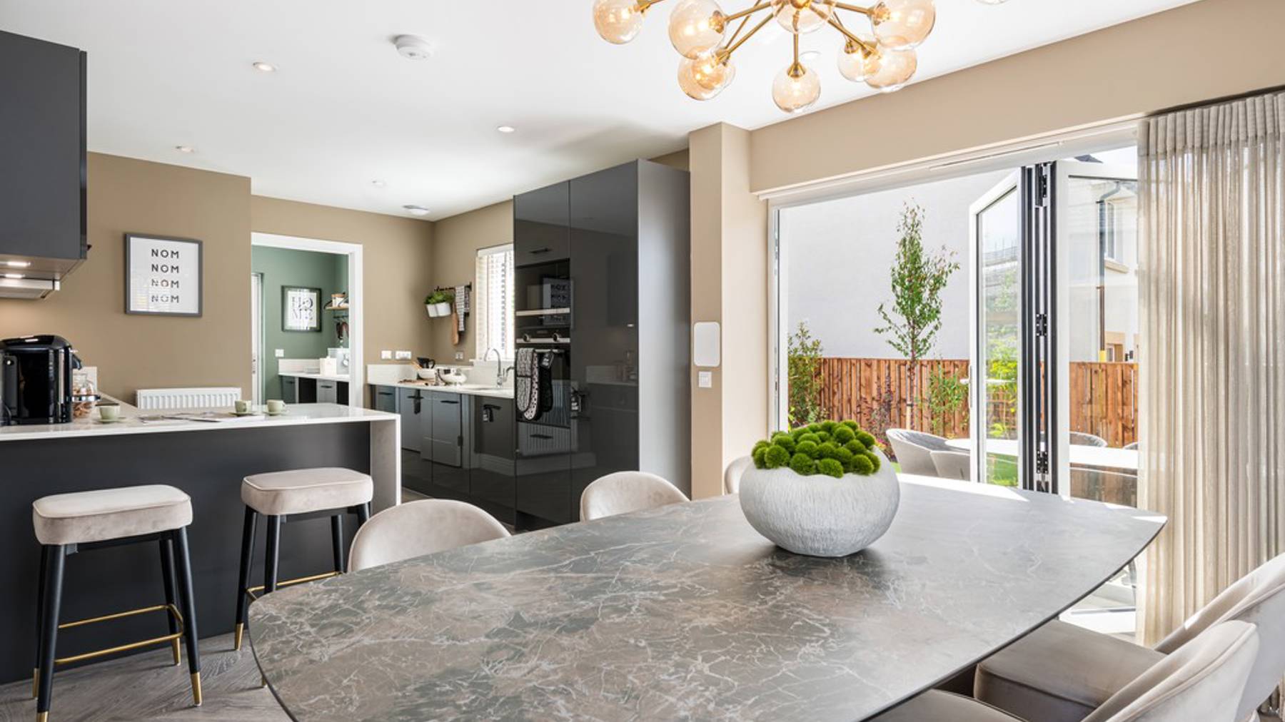 4 bedroom showhome | open plan high spec kitchen and dining area with bi-fold doors to the garden